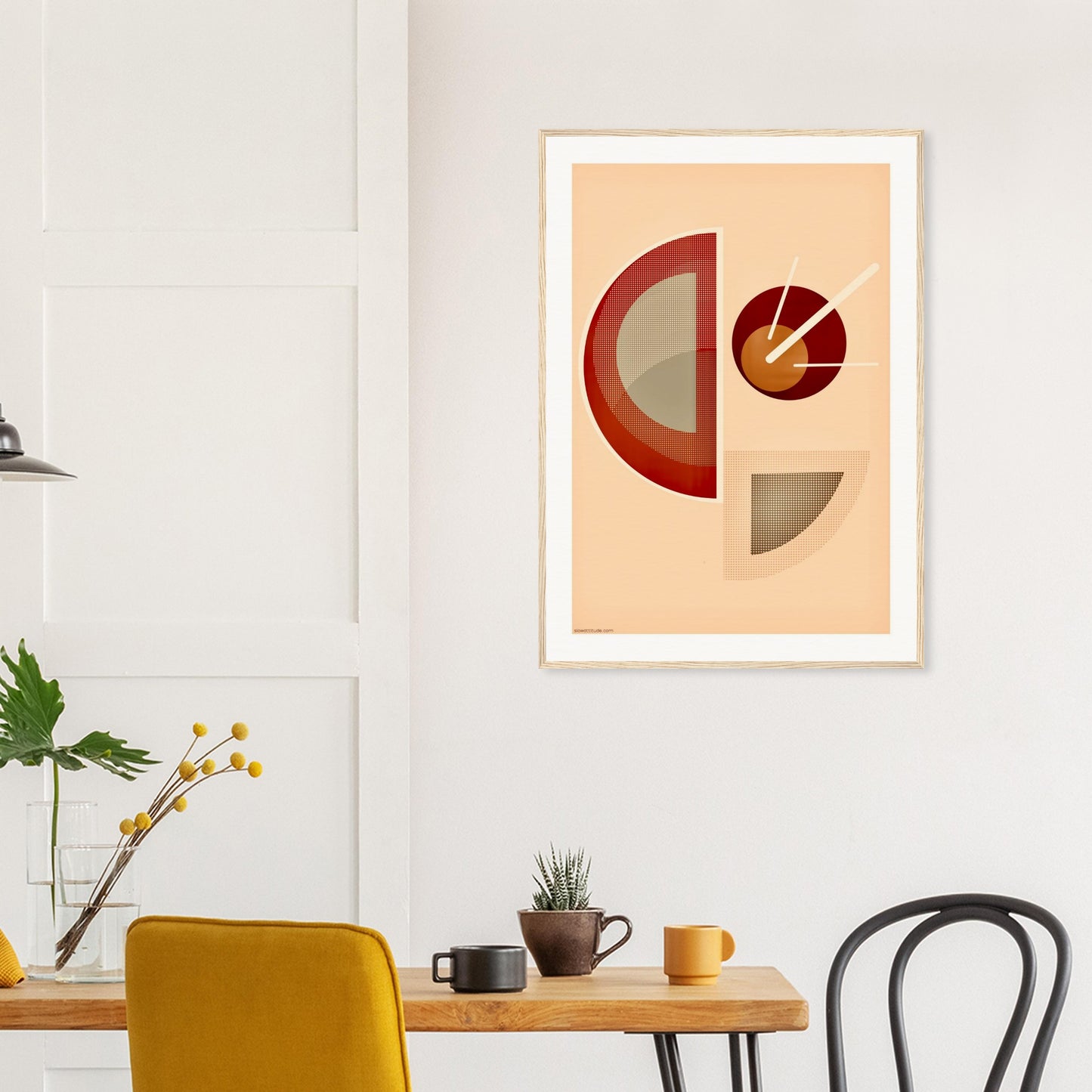 Abstract art print on a wall above a desk with chairs