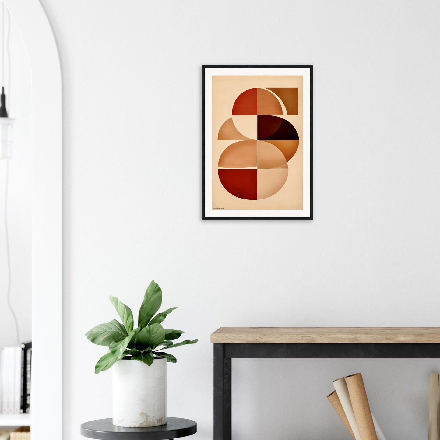 Modern Abstract art print on a wall above a desk with a plant