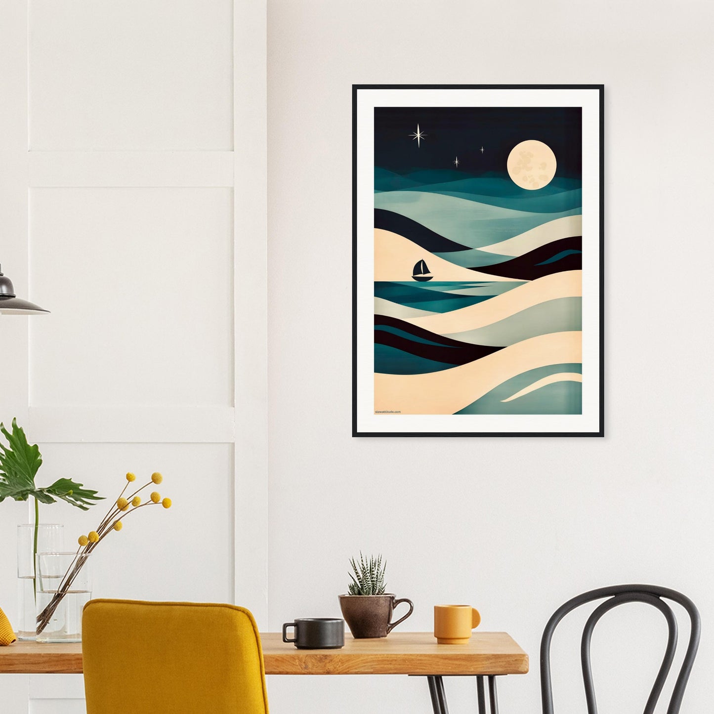 Framed abstract artwork of a night sky with waves and a sailboat above a dining table.
