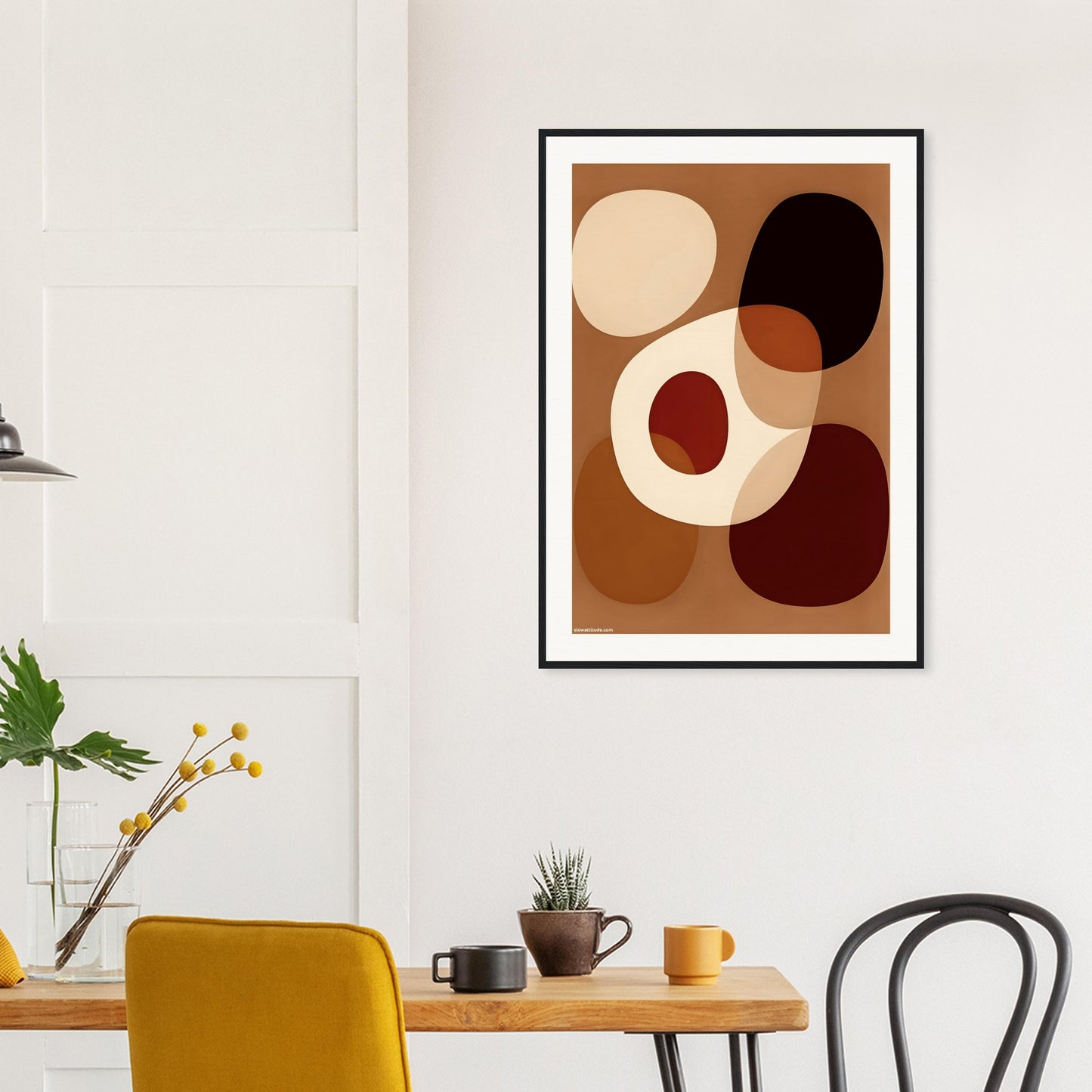 Abstract art print in a modern interior setting with a table and chairs.