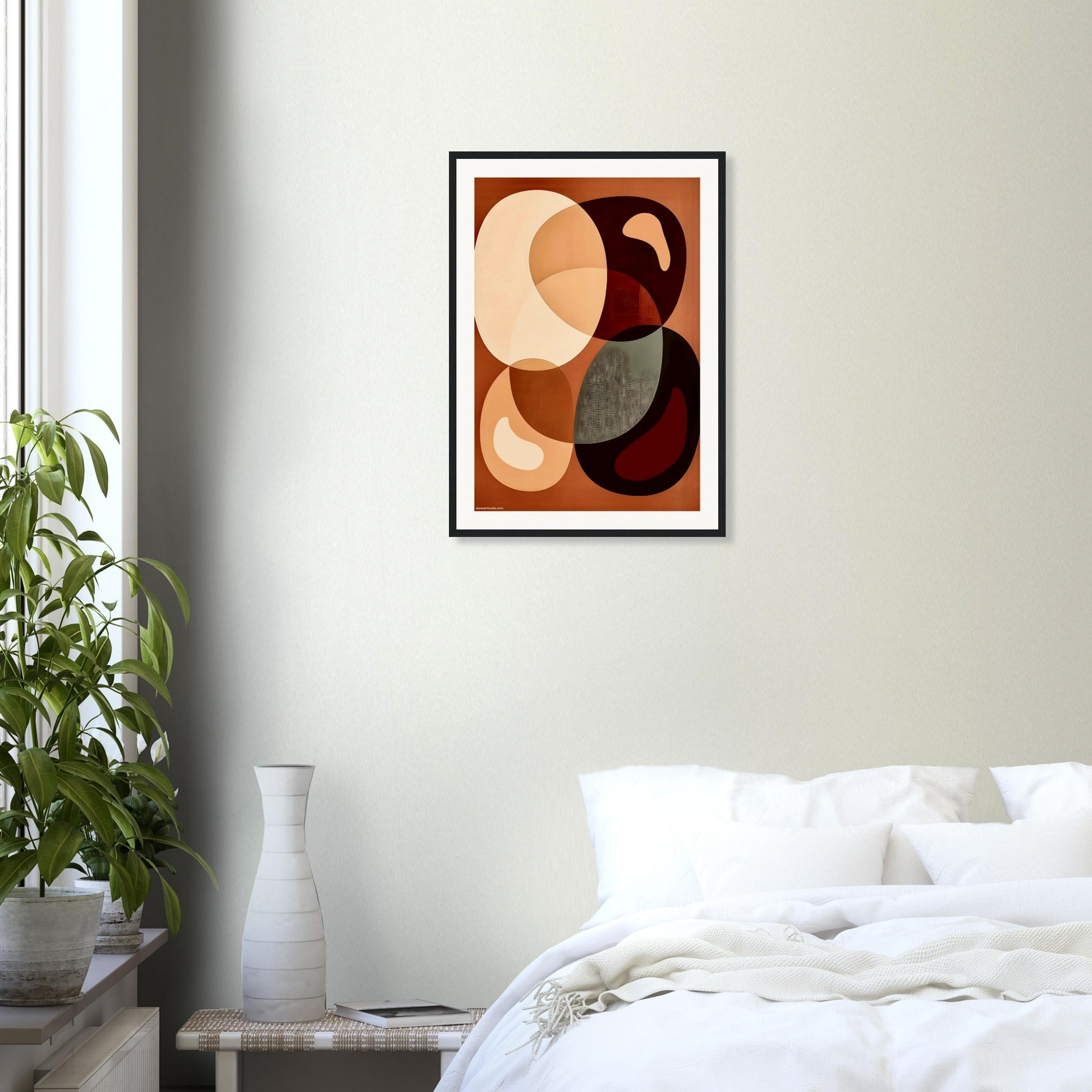 Abstract art print on a wall above a bed in a bedroom setting