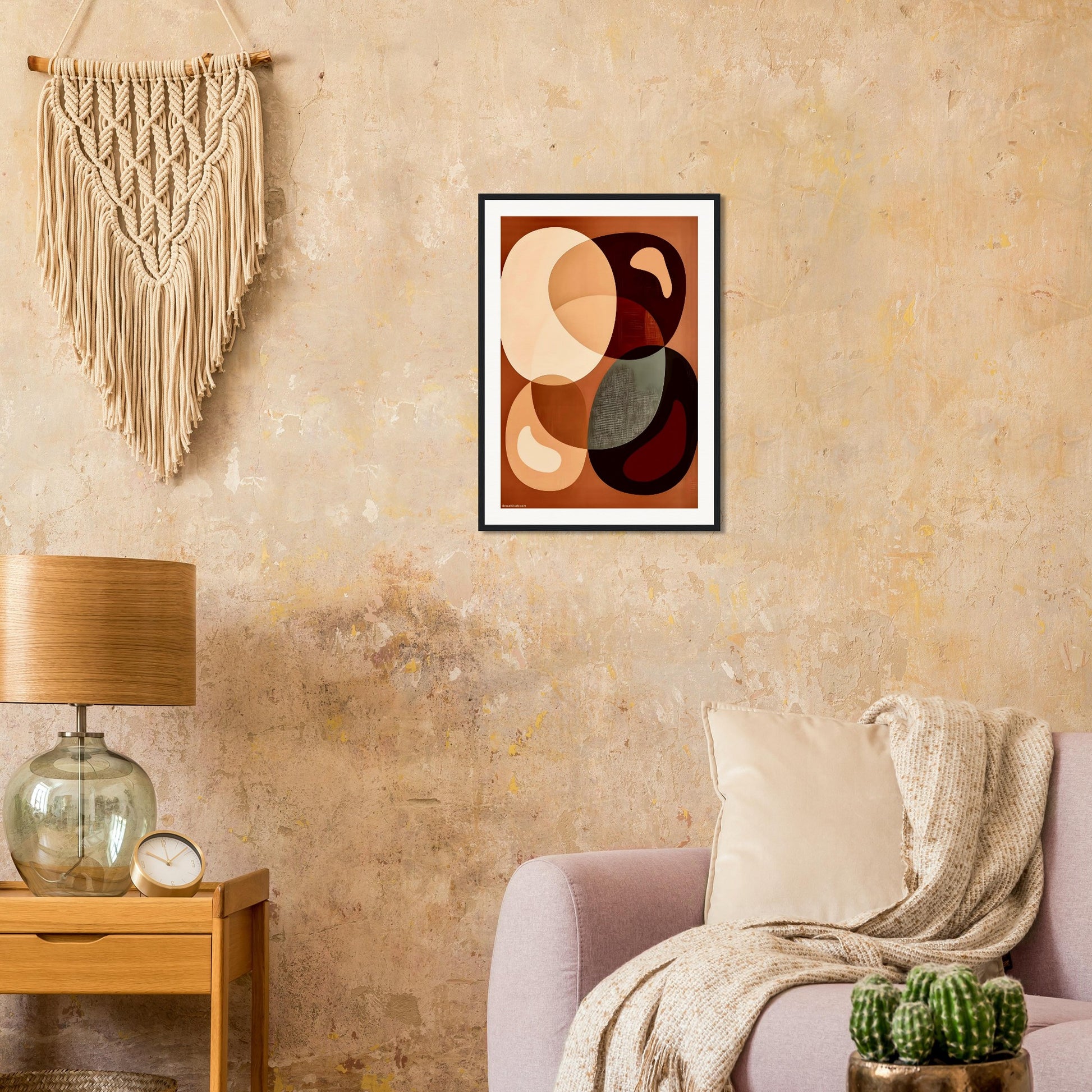 Boho living room with framed abstract art on the wall, lamp, and decorative elements.