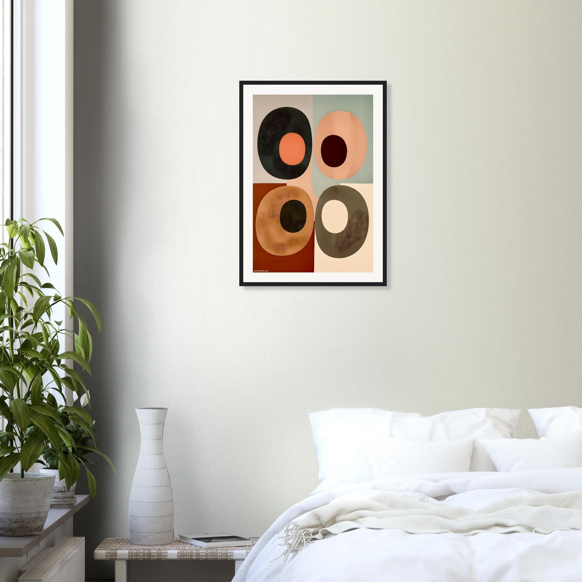 Framed abstract boho wall art printed on museum matte finish paper placed on a wall above a bed in a bedroom.