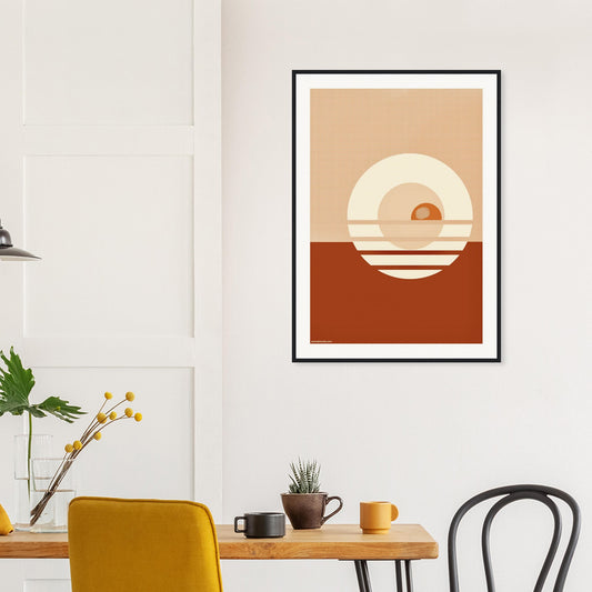 Framed abstract geometric art print featuring a stylised sunset on a wall, printed on museum quality matte paper, above a wooden table with chairs.