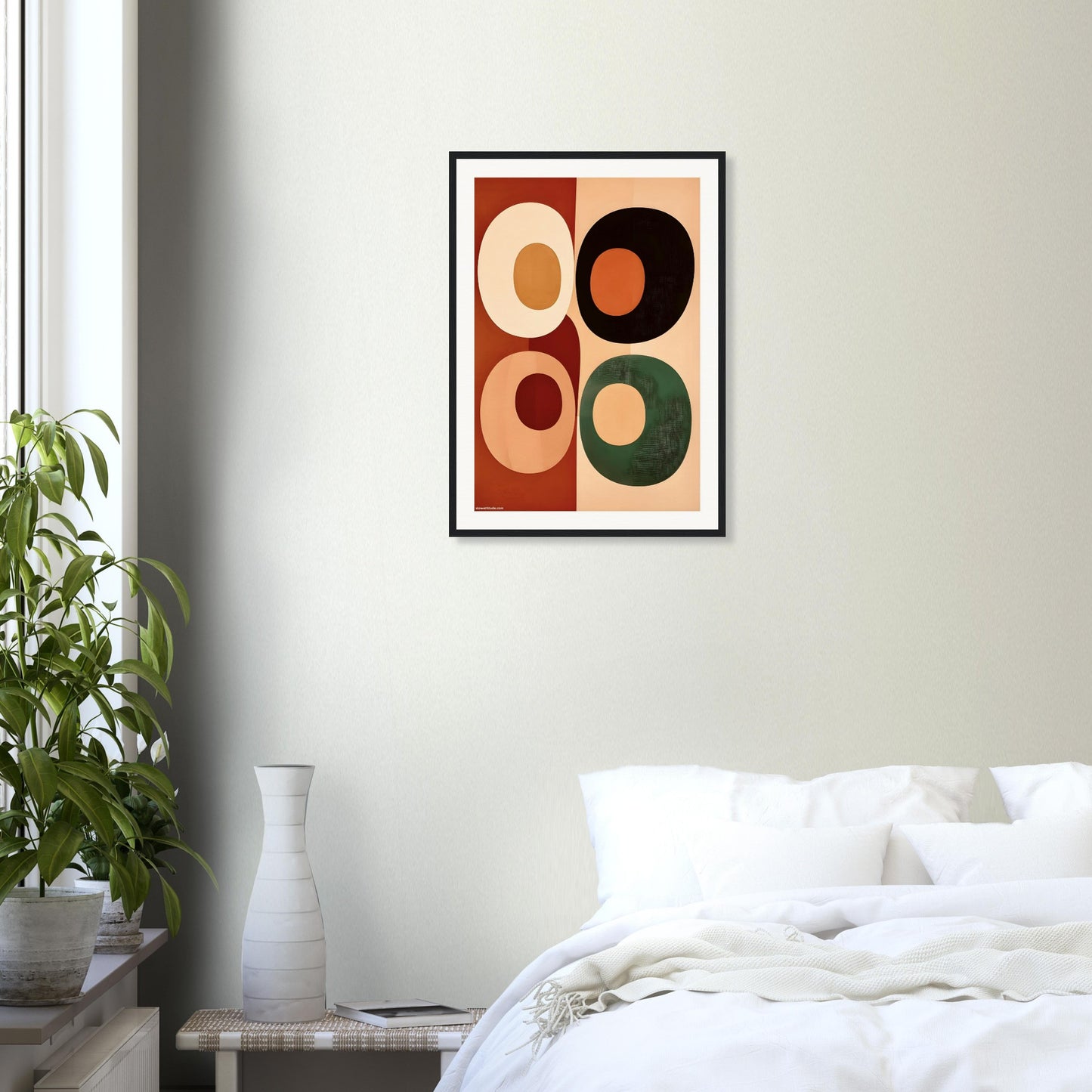 Framed abstract art piece on a wall above a bed in a bedroom.