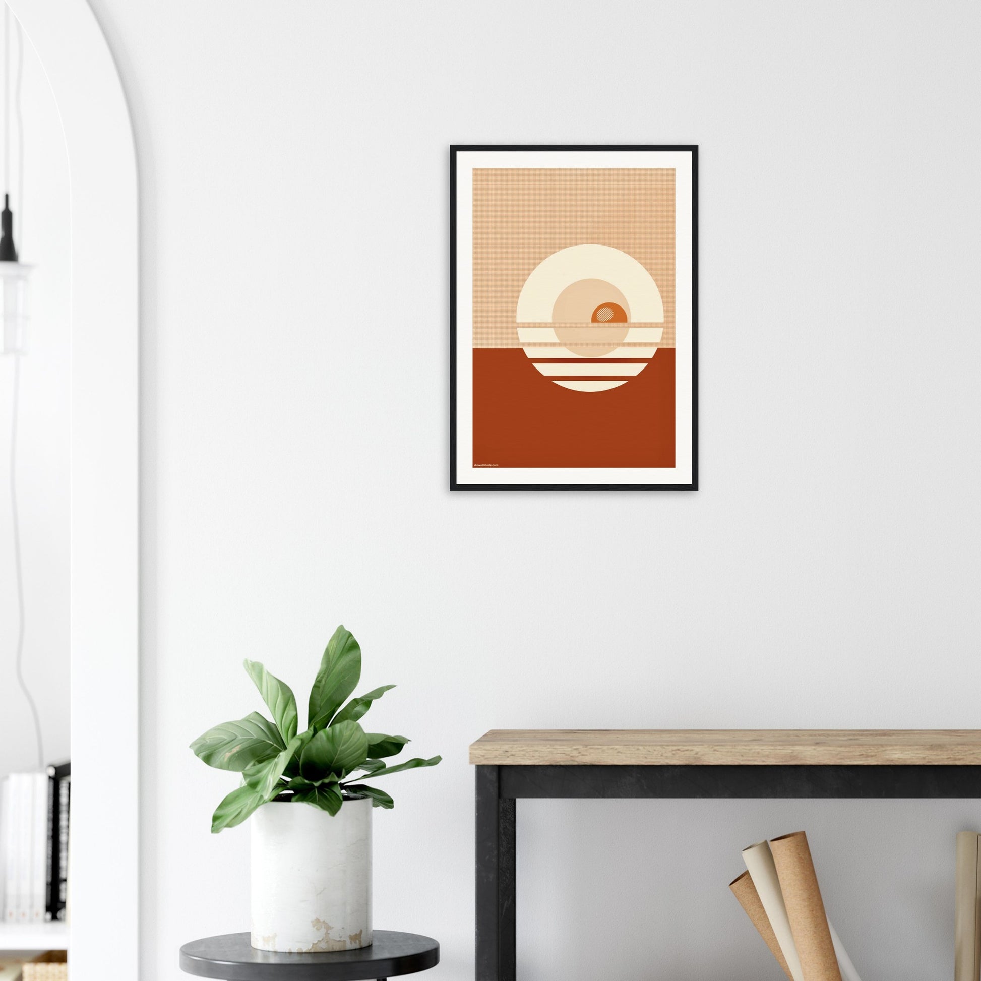 Framed abstract art piece on a wall featuring stylised sunset 