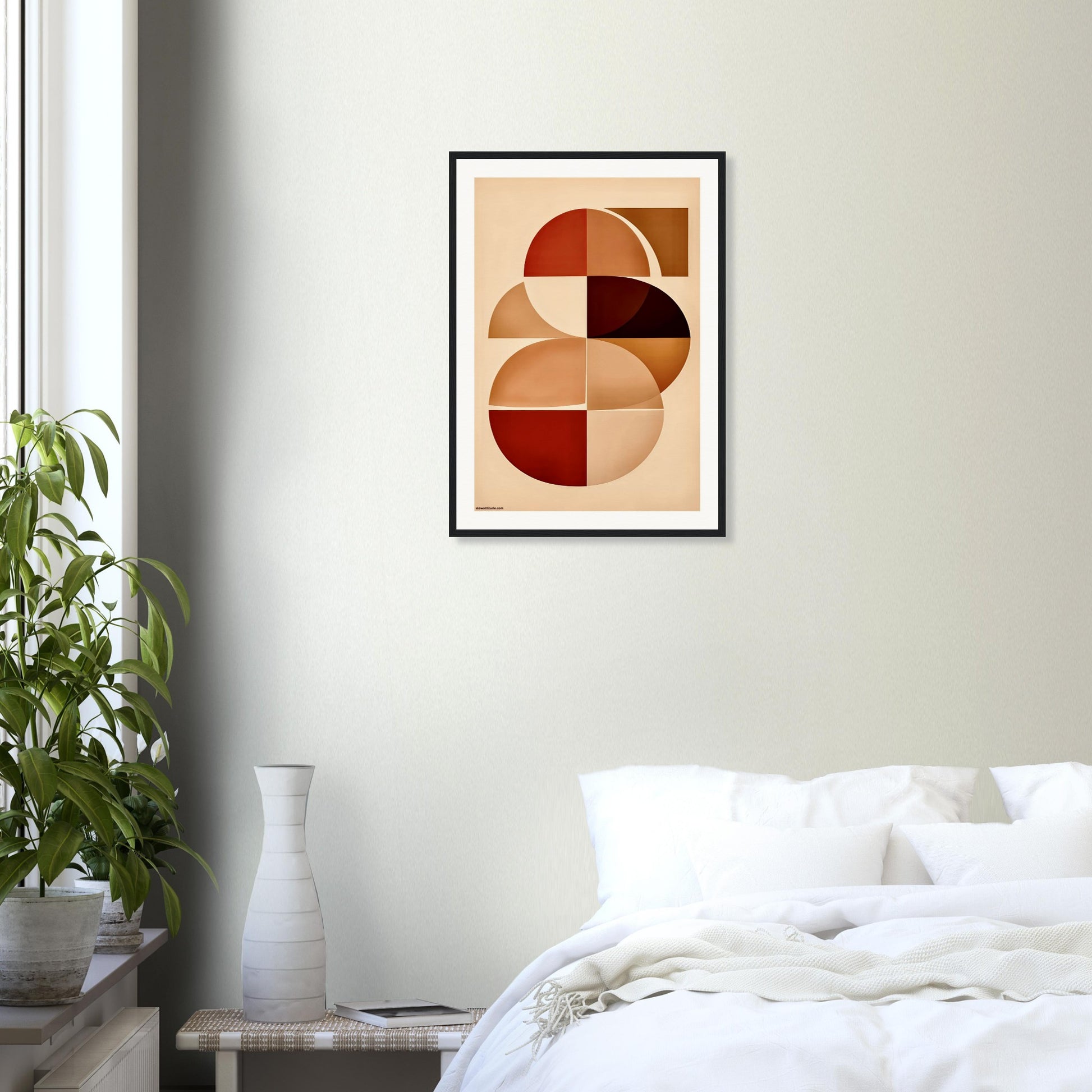 Framed abstract art piece on a wall above a bed in a bedroom.