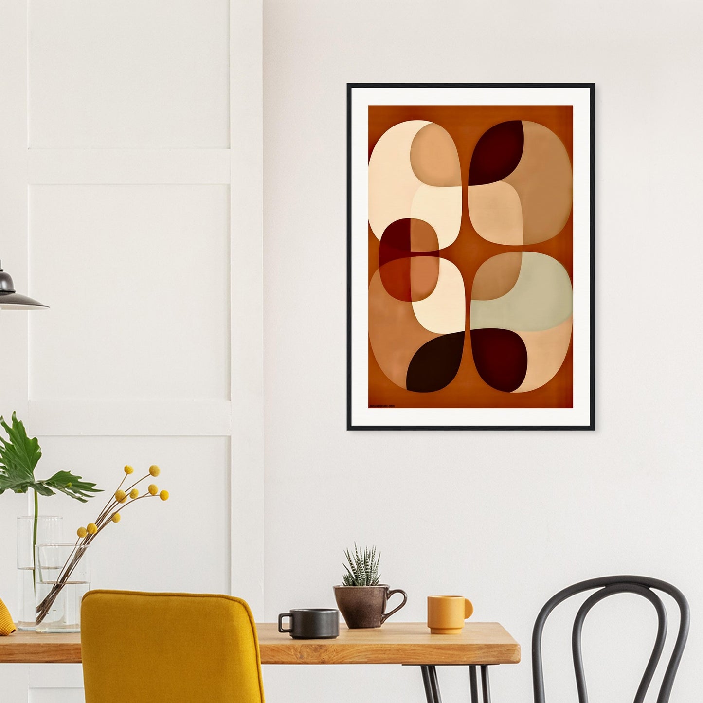 Abstract framed art print in a modern interior setting with a table and chairs.